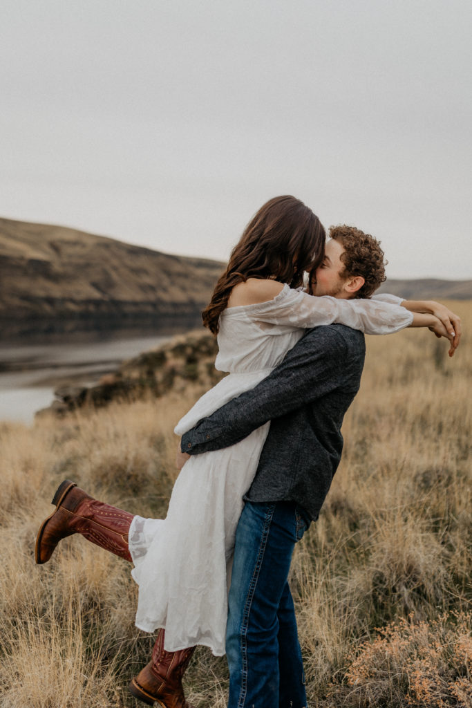 couple embracing with view of the snake river