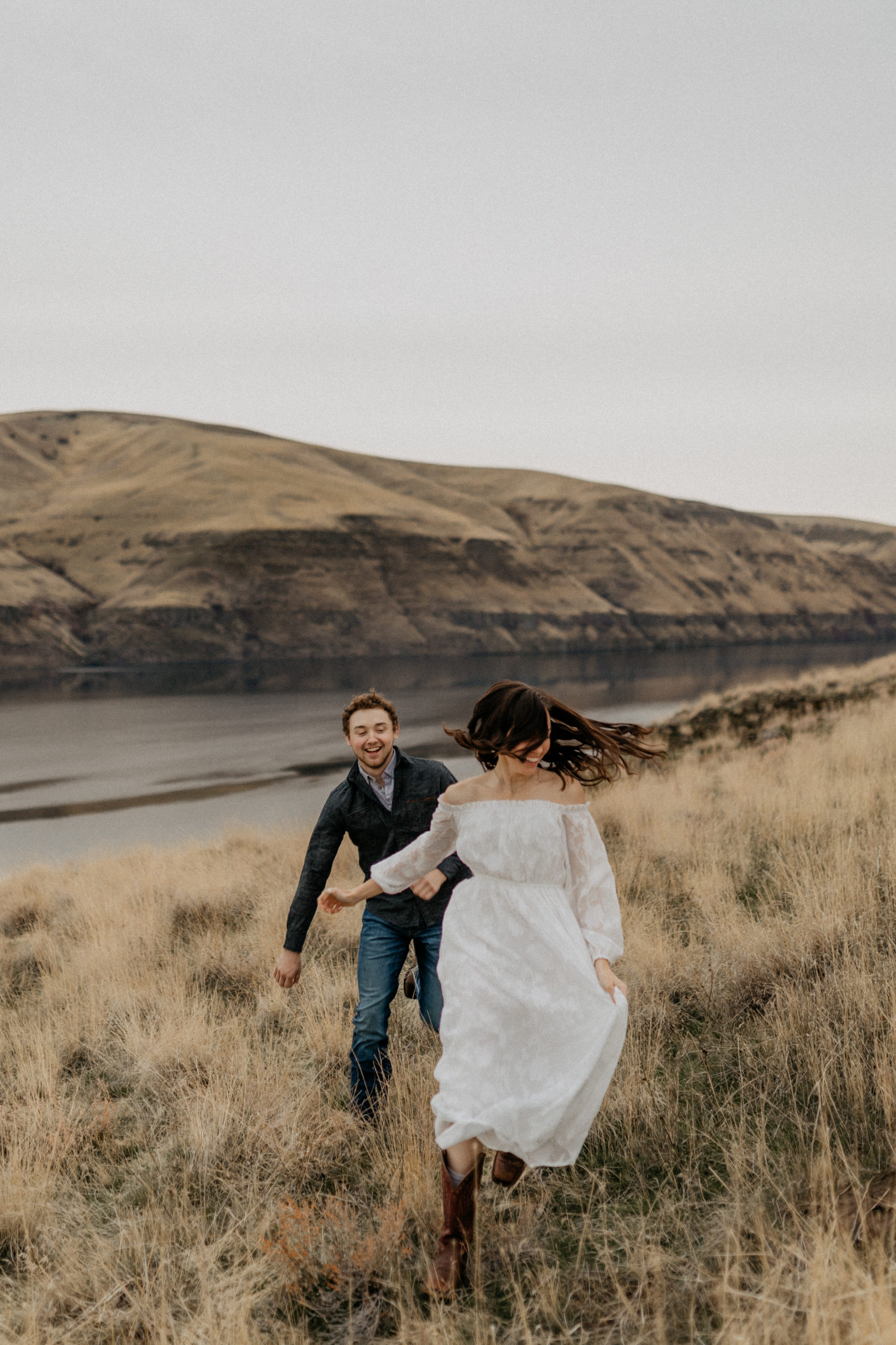 couple running with view of the snake river