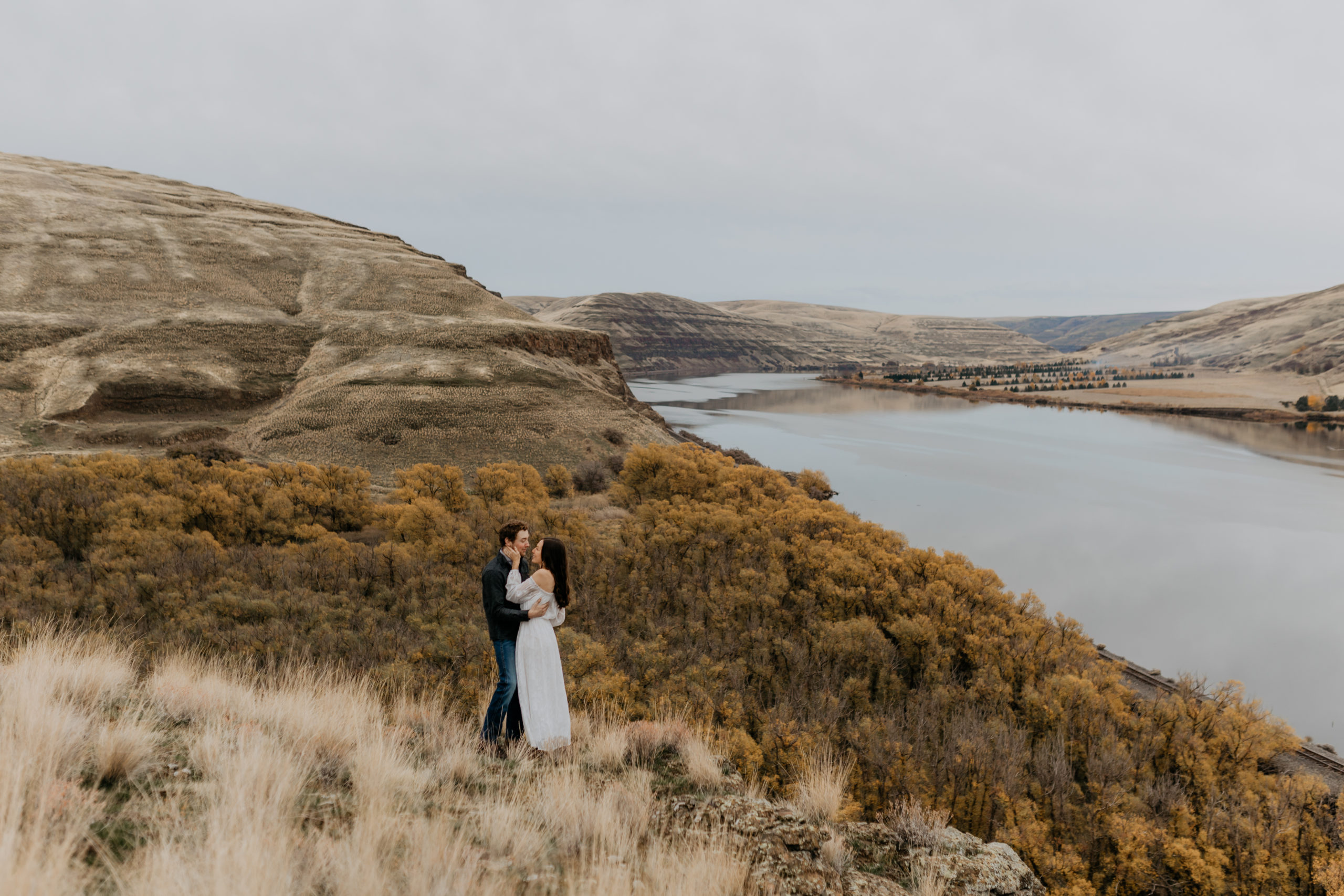 couple embracing with view of the snake river