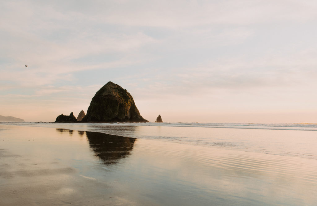 Landscape image of the Oregon coast at canon beach during sunset. 