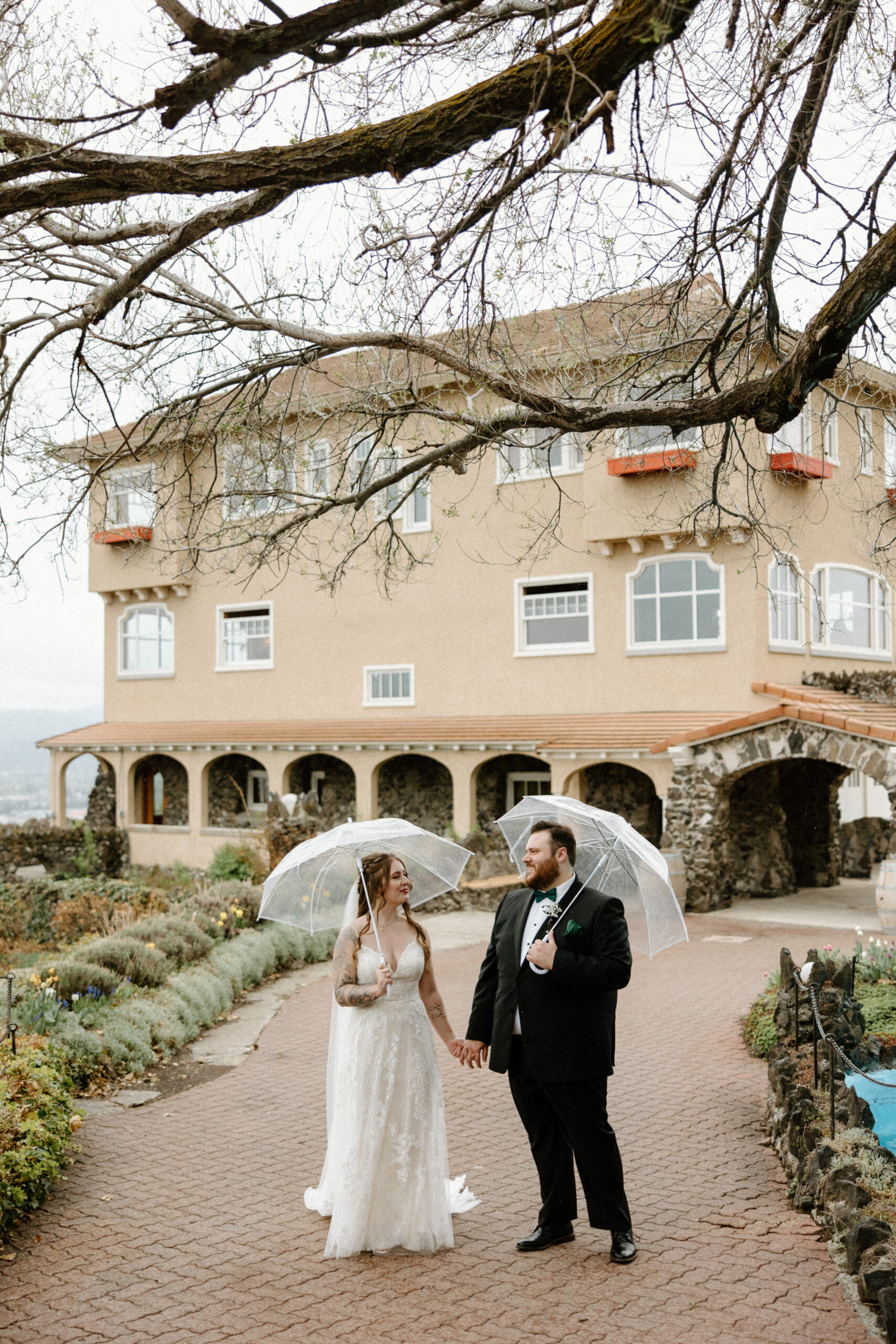 Bride and groom walking in the rain at Arbor Crest