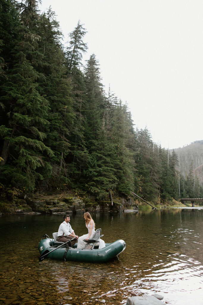 Bride and groom rafting in the river on their wedding day