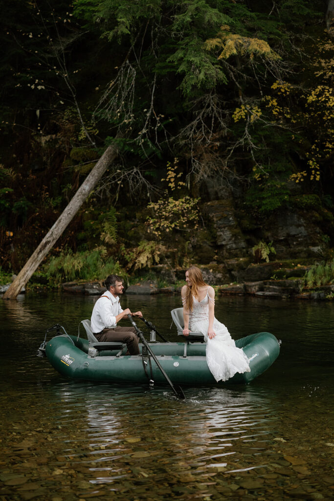 Bride and groom rafting in the river on their wedding day