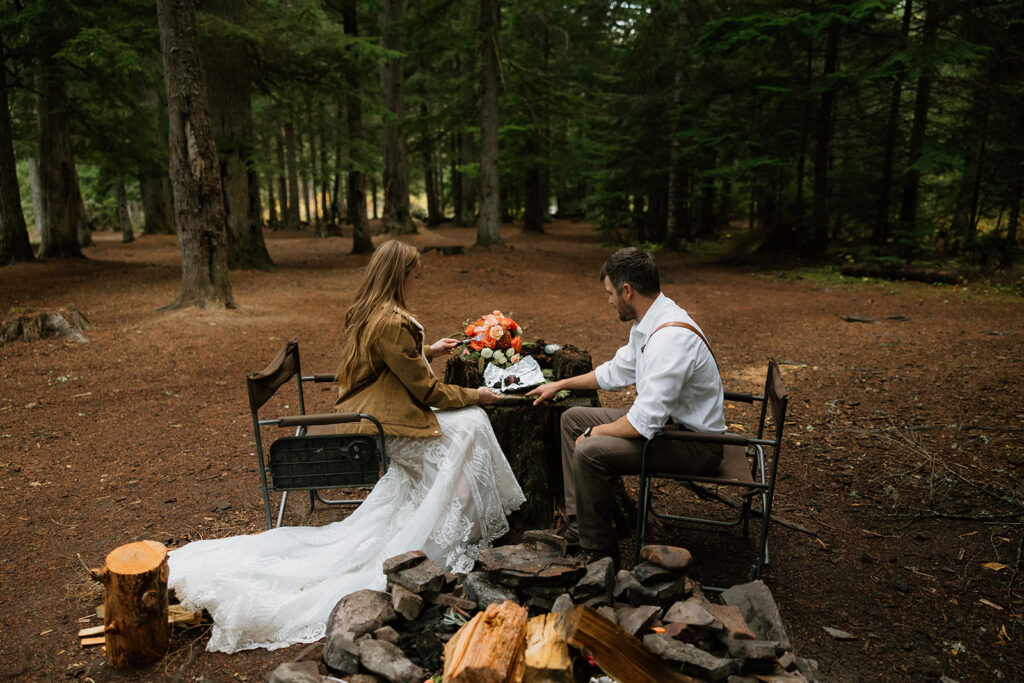 bride and groom eating cake during elopement photos