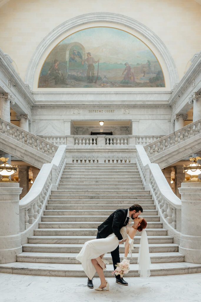 Bride and groom kissing in the rotunda of the Utah State Capitol 